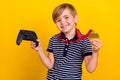 Photo portrait little boy wearing golden medal prize for best video games player isolated vibrant yellow color Royalty Free Stock Photo