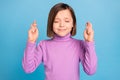 Photo portrait little girl hoping for luck with crossed fingers isolated pastel blue color background