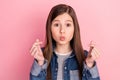 Photo portrait of little girl showing korean heart sign pouted lips on pastel pink color background
