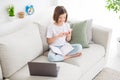 Photo portrait little girl sitting on couch browsing internet with mobile phone