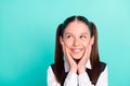 Photo portrait little girl smiling happy amazed touching cheek looking blank space isolated pastel teal color background