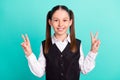 Photo portrait little girl smiling showing v-sign gesture isolated pastel turquoise color background Royalty Free Stock Photo