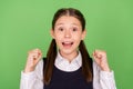 Photo portrait little girl smiling wearing uniform gesturing like winner  pastel green color background Royalty Free Stock Photo