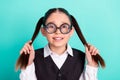 Photo portrait little girl wearing glasses keeping two ponytails isolated pastel turquoise color background Royalty Free Stock Photo