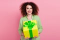Photo portrait of lovely young lady hold giving big giftbox dressed stylish green garment isolated on pink color Royalty Free Stock Photo