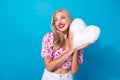 Photo portrait of lovely young lady hold plush white heart pillow wear trendy pink cherry print garment on blue