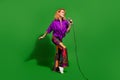 Photo portrait of lovely young lady singing enjoy karaoke hold microphone dressed stylish violet clothes isolated on