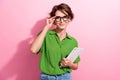 Photo portrait of lovely young lady touch specs hold ereader intelligent wear trendy green garment isolated on pink