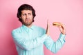 Photo portrait of man refusing to eat disgusting cheeseburger isolated on pastel pink colored background