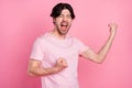 Photo portrait man wearing casual t-shirt won lottery shouting overjoyed isolated pastel pink color background Royalty Free Stock Photo