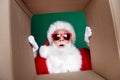 Photo portrait of mature pensioner man peek inside carton box dressed stylish santa claus costume coat isolated on green Royalty Free Stock Photo