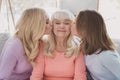 Photo portrait of mother daughter kissing lovely overjoyed granny cute family spending time on holidays Royalty Free Stock Photo