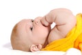 Newborn lies on back and holds finger in mouth Royalty Free Stock Photo