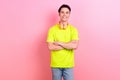 Photo portrait of nice teen man crossed hands confident pose wear trendy yellow clothes isolated on pink color Royalty Free Stock Photo