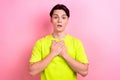 Photo portrait of nice teen man touch chest frightened amazed reaction wear trendy yellow clothes isolated on pink color Royalty Free Stock Photo