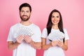 Photo portrait of nice young couple hold money banknotes fan dollars wear trendy white clothes isolated on pink color Royalty Free Stock Photo