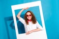 Photo portrait of nice young lady sunglass hold instant photo frame cheerful wear trendy white garment isolated on blue Royalty Free Stock Photo