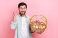 Photo portrait of nice young male raise fist excited hold basket easter eggs wear trendy blue garment isolated on pink Royalty Free Stock Photo