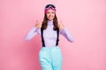 Photo portrait of positive woman raising two thumbs up isolated on pastel pink colored background Royalty Free Stock Photo