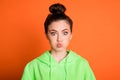 Photo portrait of pouting girl isolated on vivid orange colored background Royalty Free Stock Photo