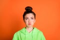 Photo portrait of pouting girl looking up isolated on vivid orange colored background Royalty Free Stock Photo