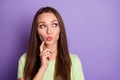 Photo portrait of pouting girl thinking touching face cheek with finger isolated on vivid violet colored background