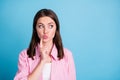 Photo portrait of pouting girl touching face cheek with finger looking at blank space isolated on pastel blue colored Royalty Free Stock Photo