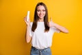 Photo portrait of pretty brunette girl showing like gesture with finger keeping bottle with vitamins isolated vivid