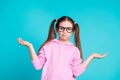 Photo portrait of pretty little girl specs shrug shoulders wear trendy pink outfit isolated on aquamarine color