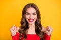 Photo portrait of pretty model gesturing like winner smiling isolated on vivid yellow color background