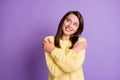 Photo portrait of pretty nice girl smiling embracing herself enjoying dreaming looking at blank space wearing yellow Royalty Free Stock Photo