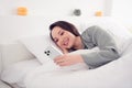 Photo portrait of pretty young girl lying bed read post device dressed stylish gray nightwear  on comfortable Royalty Free Stock Photo