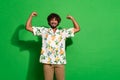 Photo portrait of pretty young male showing muscles fists wear trendy citrus print outfit isolated on green color Royalty Free Stock Photo