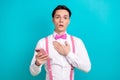 Photo portrait of pretty young male touch chest frightened hold device wear trendy pink outfit isolated on cyan color Royalty Free Stock Photo