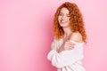 Photo portrait of red haired curly woman smiling laughing cuddling herself dreamy isolated on pastel pink color Royalty Free Stock Photo