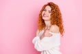 Photo portrait of red haired curly woman smiling laughing embracing herself isolated on pastel pink color background Royalty Free Stock Photo