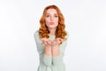 Photo portrait of red haired girl sending air kiss with pouted lips isolated white color background Royalty Free Stock Photo