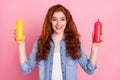 Photo portrait red haired girl showing tongue keeping ketchup mustard sauces isolated pastel pink color background Royalty Free Stock Photo