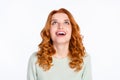 Photo portrait of red haired young girl looking up amazed with opened mouth isolated on white color background Royalty Free Stock Photo