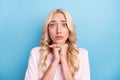 Photo portrait sad woman asking a wish need help isolated pastel blue color background Royalty Free Stock Photo