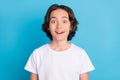 Photo portrait schoolboy smiling amazed excited in white t-shirt isolated pastel blue color background