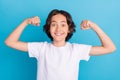 Photo portrait schoolboy smiling showing strong hands isolated pastel blue color background