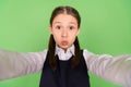 Photo portrait schoolgirl sending air kiss pouted lips taking selfie in uniform isolated pastel green color background