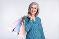 Photo portrait of senior business woman in glasses keeping bags on shopping sale smiling  on white color Royalty Free Stock Photo