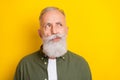 Photo portrait of senior man doubtful unsure looking copyspace isolated on bright yellow color background