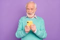 Photo portrait of senior man using mobile phone typing message happy isolated on pastel purple color background Royalty Free Stock Photo