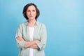 Photo portrait senior woman serious calm folded hands looking copyspace isolated pastel blue color background