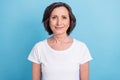 Photo portrait senior woman smiling in white t-shirt isolated pastel blue color background Royalty Free Stock Photo