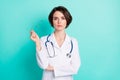 Photo portrait of serious nurse wearing white uniform keeping glasses isolated bright teal color background