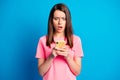 Photo portrait of shocked astonished female student browsing internet cellphone isolated on vibrant blue color Royalty Free Stock Photo